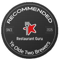 A round black badge featuring the text "RECOMMENDED Restaurant Guru Ye Olde Two Brewers" with a red star and fork, and "Since 2025" written on either side.